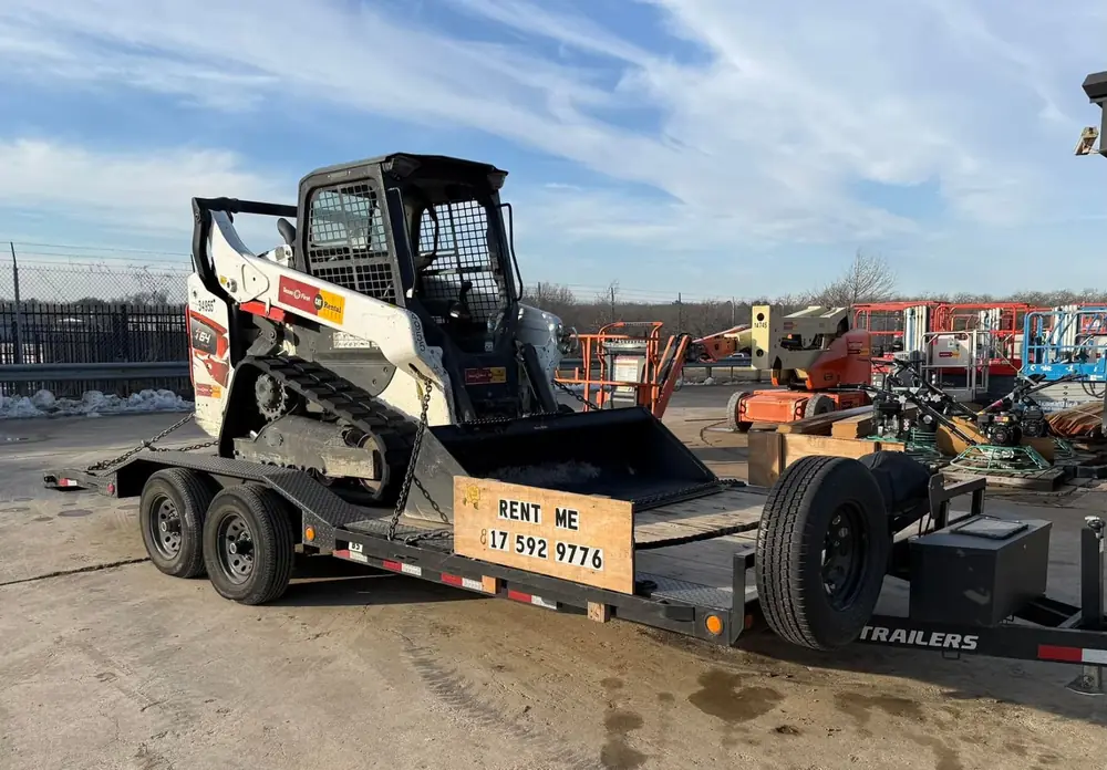 Compact track loader skid steer loaded on the car hauler trailer