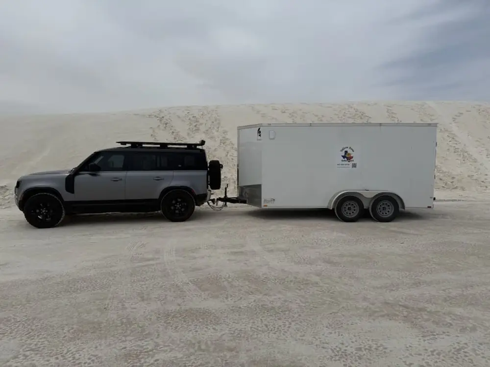 Gray SUV towing the white 7 x 14 ft enclosed trailer