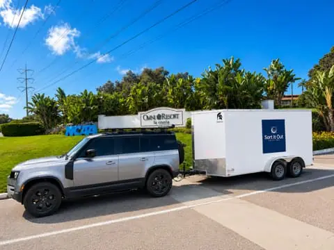 Gray Land Rover Defender towing the 7 x 14 ft enclosed cargo trailer