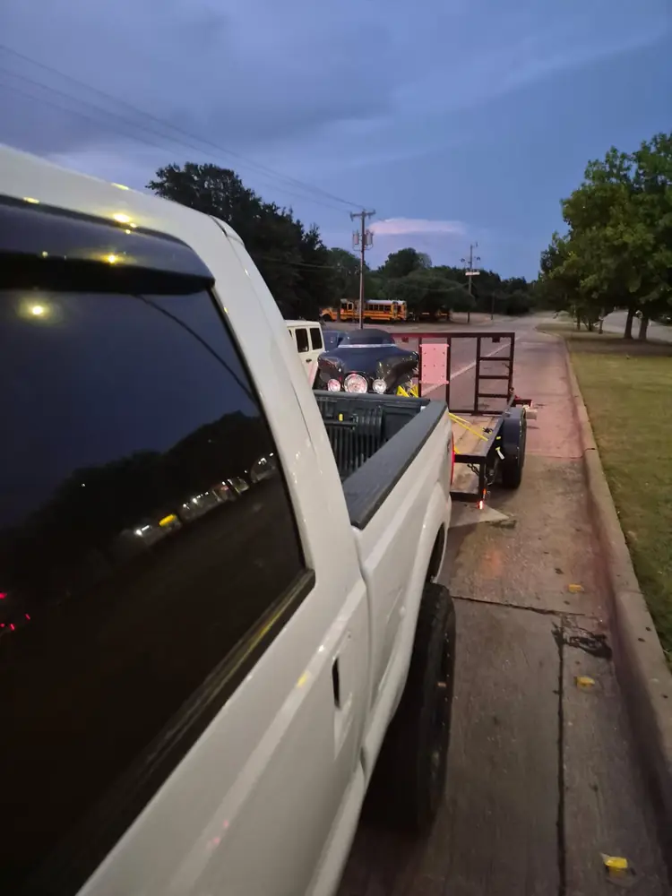 White pickup towing the 16 ft utility trailer