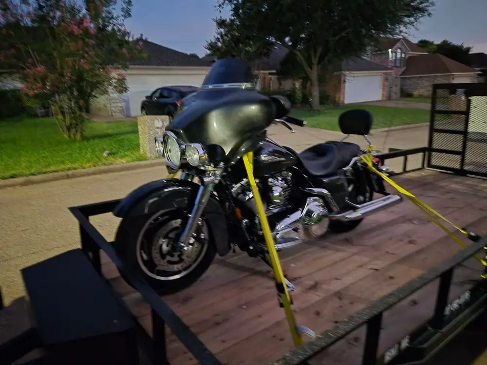 Motorcycle strapped down on the 16 ft utility trailer